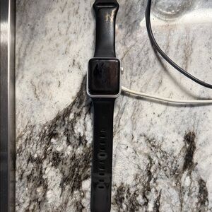 Apple Smartwatch Series 3 38 mm with Black Band, Silver Frame and charger.